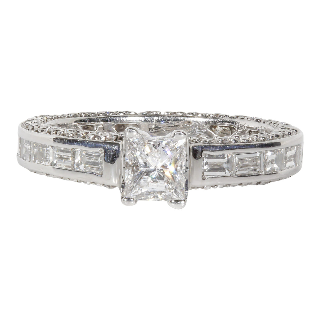 Ring in 18K WG with channel set baguettes, pave set rounds, and 4-prong set princess cut diamond center stone.  D2.52ct.t.w.  (Center 0.50ct.)