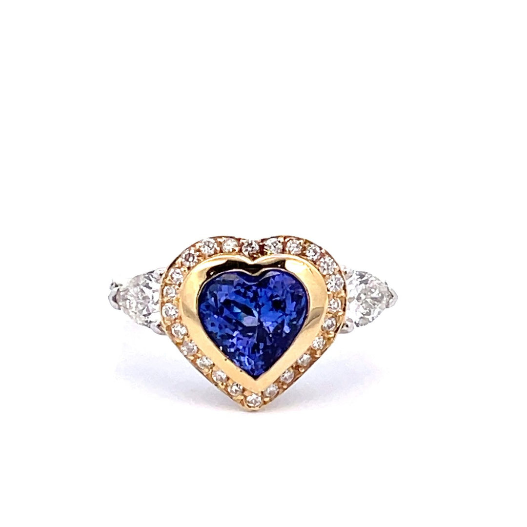 Ring in 18K WG with prong set pear shapes on the sides, prong set round diamonds & heart shaped tanzanite center.  D1.49ct.t.w.  (Tanzanite - 2.09ct.)