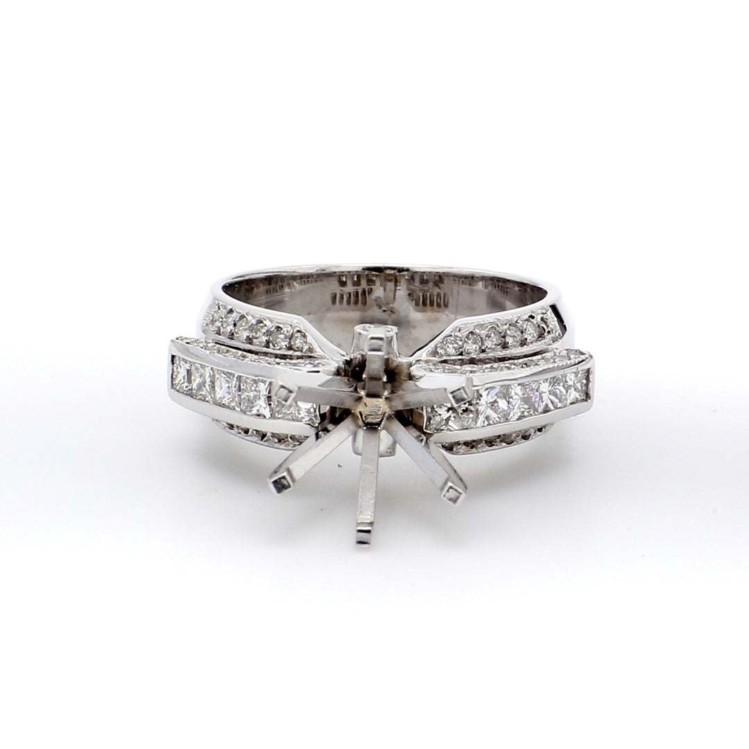 Semi-mount in 18K WG with princess cuts on top & round diamonds on the shank.  D1.05ct.t.w.