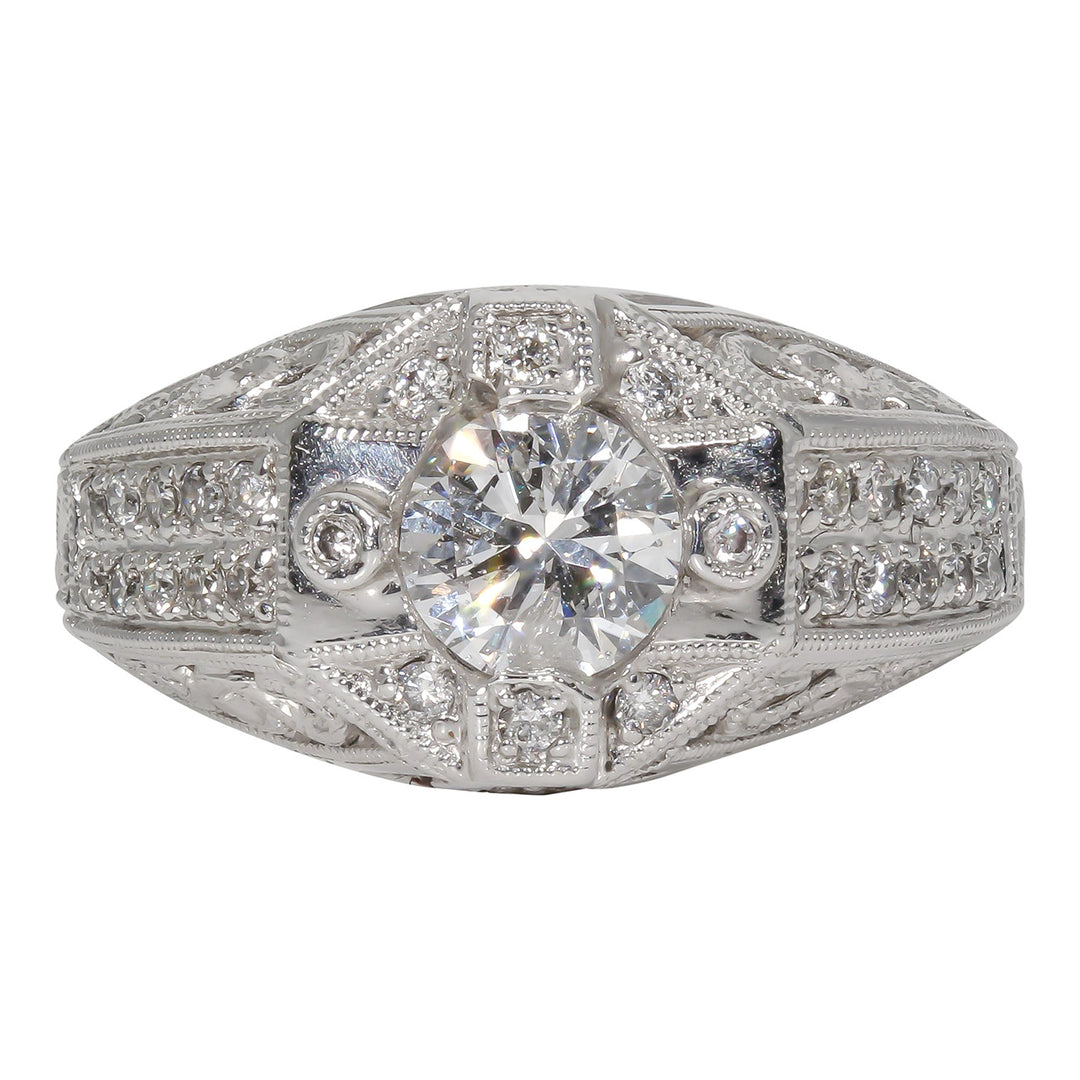 Art deco style ring in 18K WG with engravings and milligrains on the shank, pave set rounds, and prong set round center stone.  D1.31ct.t.w.  (Center 1.01ct.)