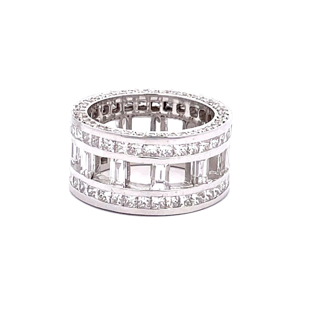 Wide eternity band w/ open channel set baguettes on the inside, channel set princess cuts on the outside, & pave set  round diamonds on the shank.  D6.16ct.t.w.