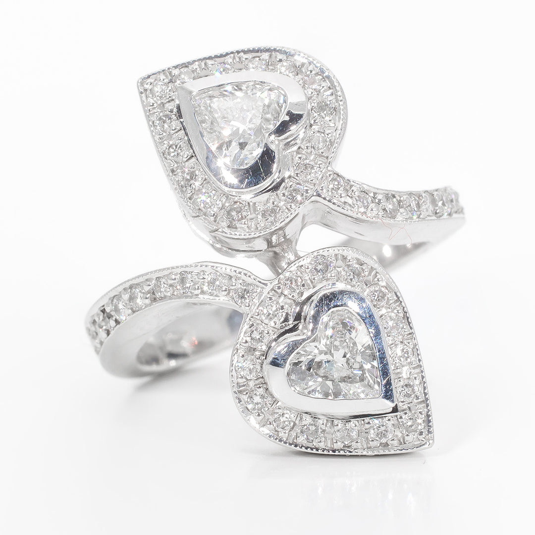 Halo fashion ring with pave set rounds around bezel set heart shape diamond center stones.  D1.22ct.t.w.