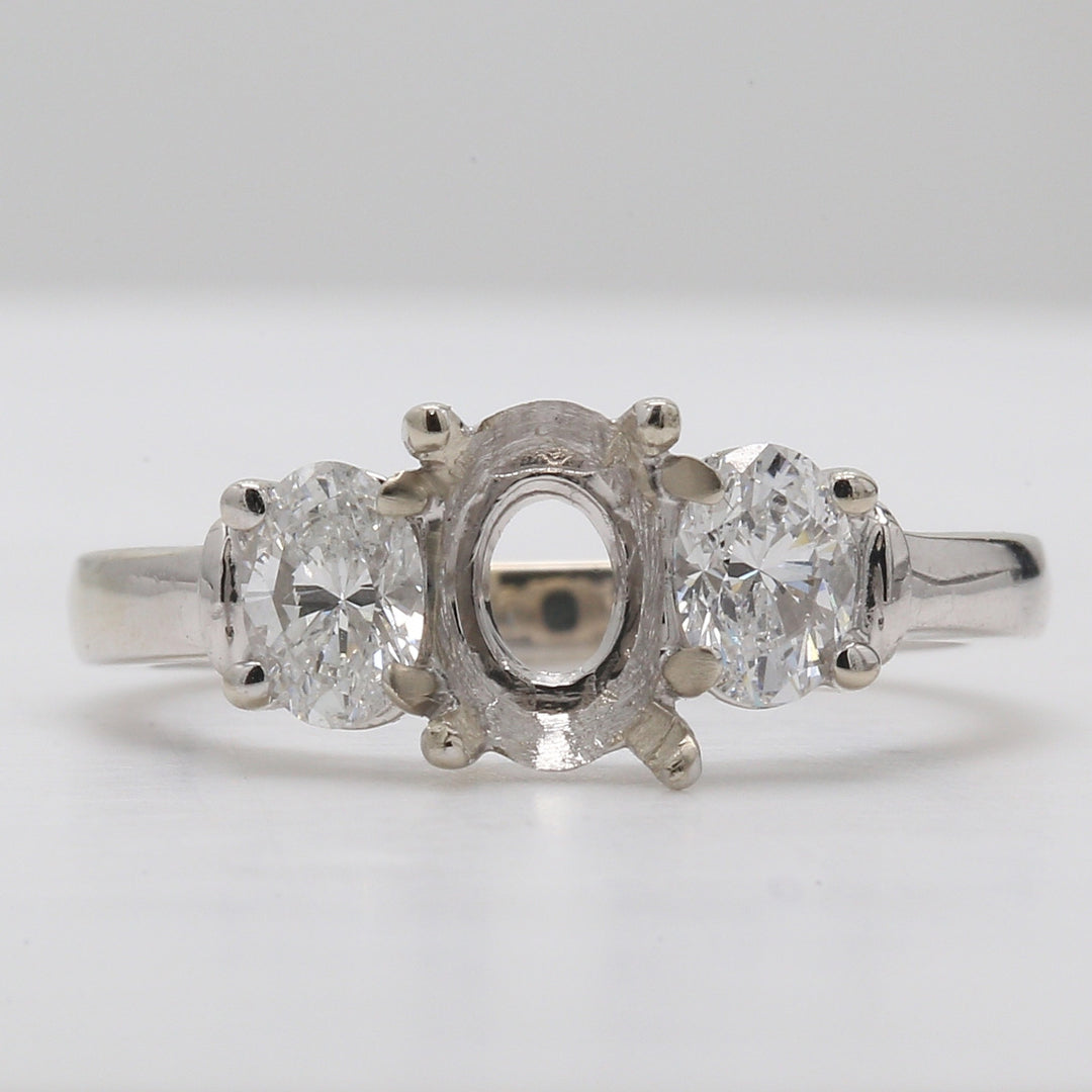 3-stone semi-mount with oval diamond sides.  D0.74ct.t.w.