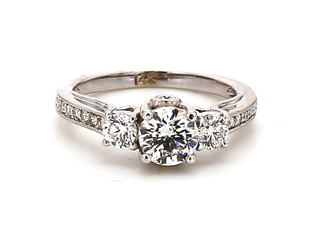 3-stone ring with 4-prong set round center & pave, prong, and bezel set round diamonds.  D1.42ct.t.w.