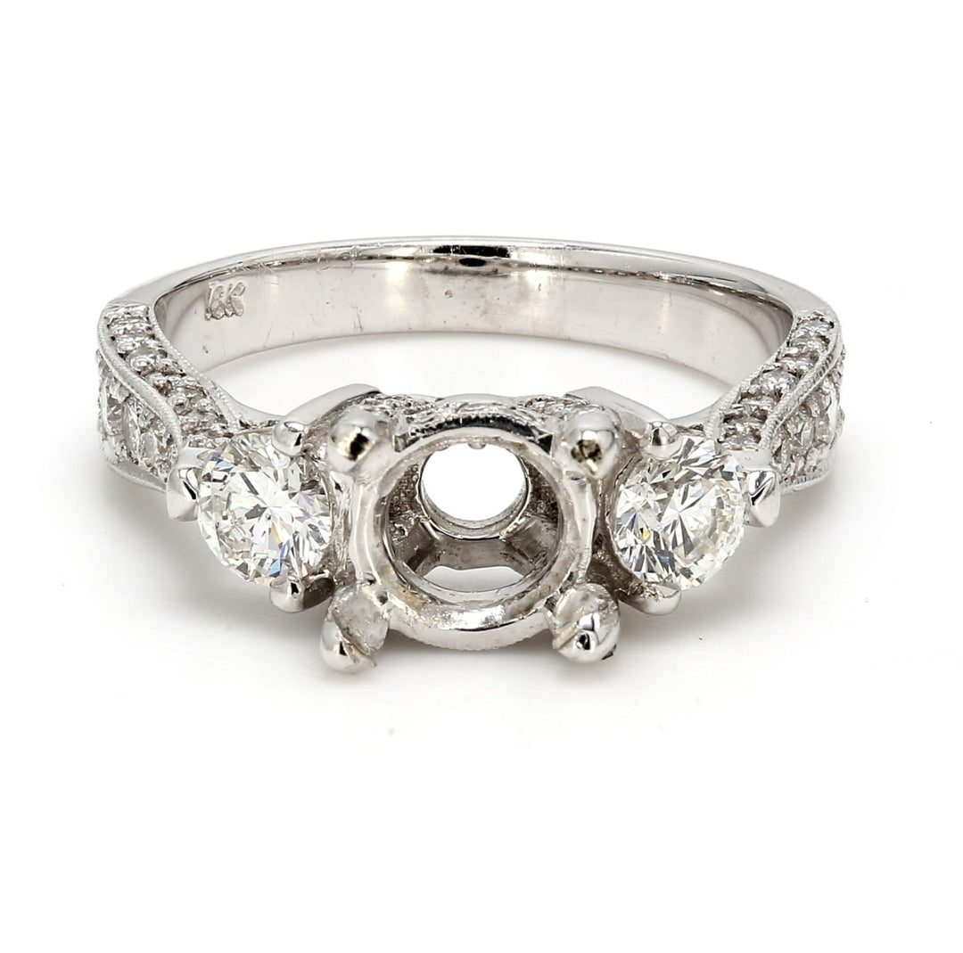 3-stone semi-mount in 18K WG with round diamonds.  D1.25ct.t.w.
