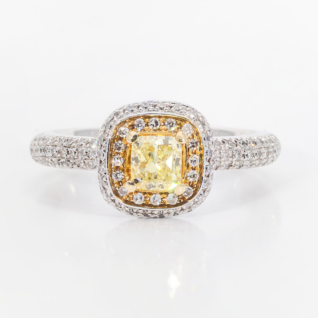Halo ring in 14K two-tone with pave rounds and 4-prong set FY cushion cut diamond center stone.  D0.99ct.t.w.  (Center 0.52ct.)