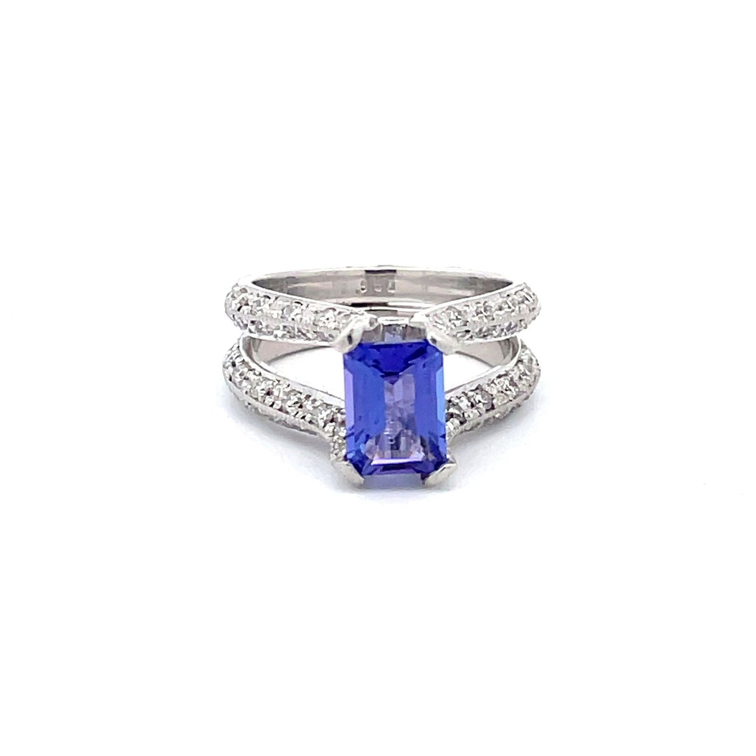 Split-shank ring in platinum with pave & bezel set round diamonds and 4-prong set emerald shape tanzanite center.  D1.25ct.t.w.  (Tanzanite - 1.79ct.)