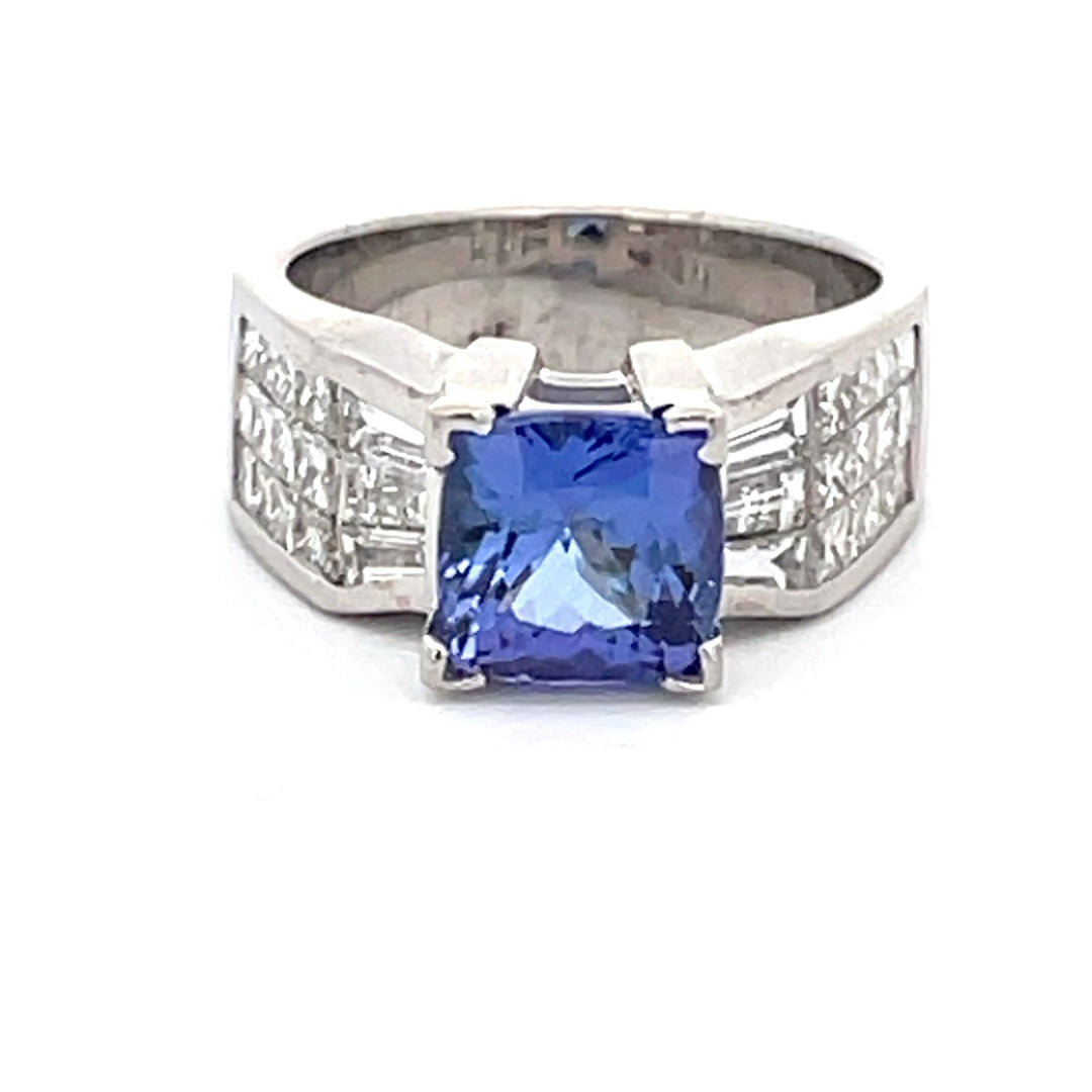 Wide ring in 18K WG with invisible set princess and baguette diamonds  & 4-prong V-tip set cushion shape Tanzanite center.  D1.36ct.t.w.  (Tanzanite - 2.26ct.)