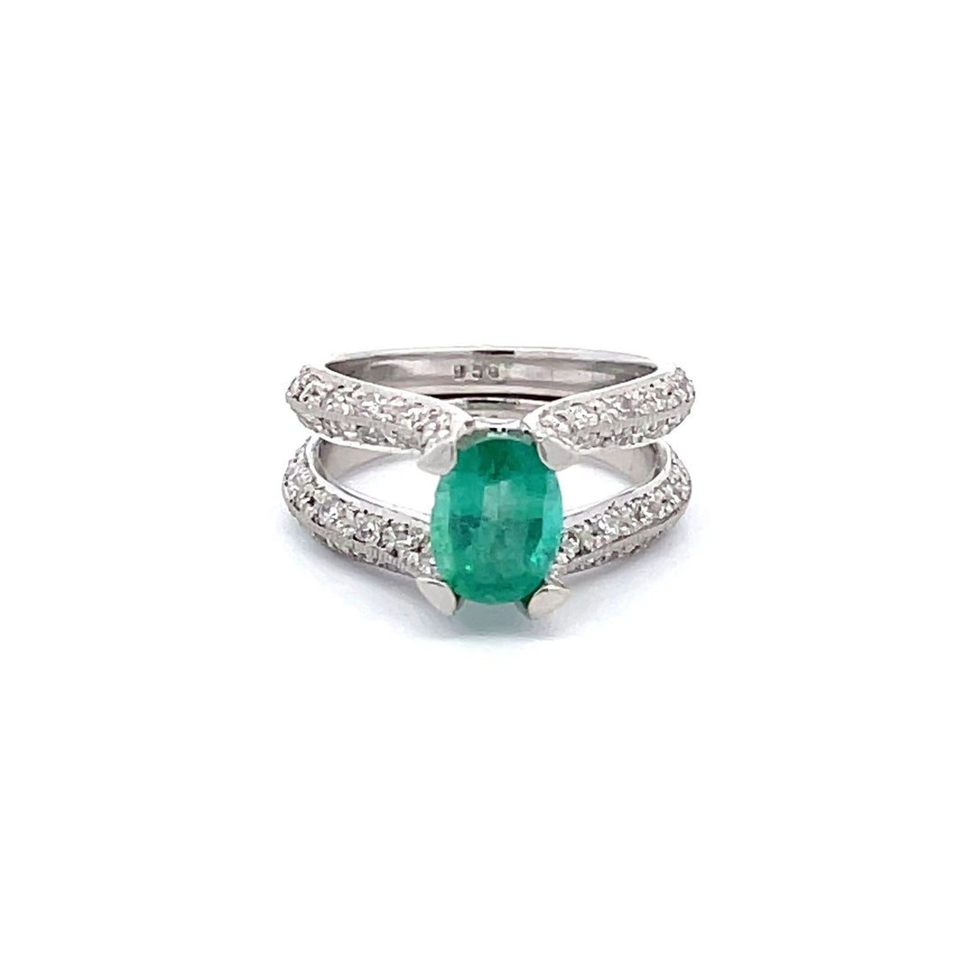 Split-shank ring in platinum with pave and bezel set round diamonds and 4-prong set oval shaped emerald center.  D1.25ct.t.w.  (Emerald - 1.22ct.)