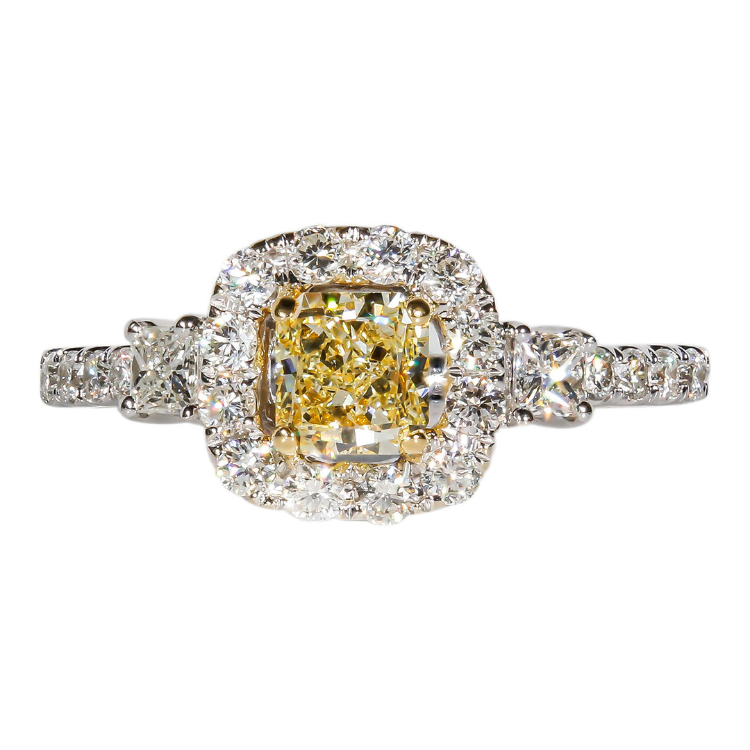 Halo ring in 18k two-tone with 4-prong set princess sides, shared prong set rounds on shank, and 4-prong set FY princess cut diamond center stone. D1.05ct.t.w.  (Center 0.53ct.)