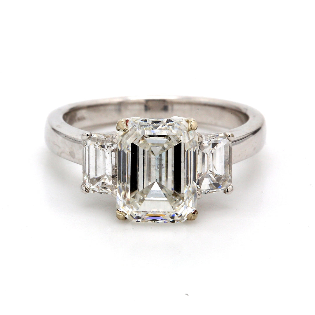 3-stone ring with emerald cut sides and GIA certified G/VS2 emerald cut diamond center stone.  D3.51ct.t.w.  (Center 2.51ct.)