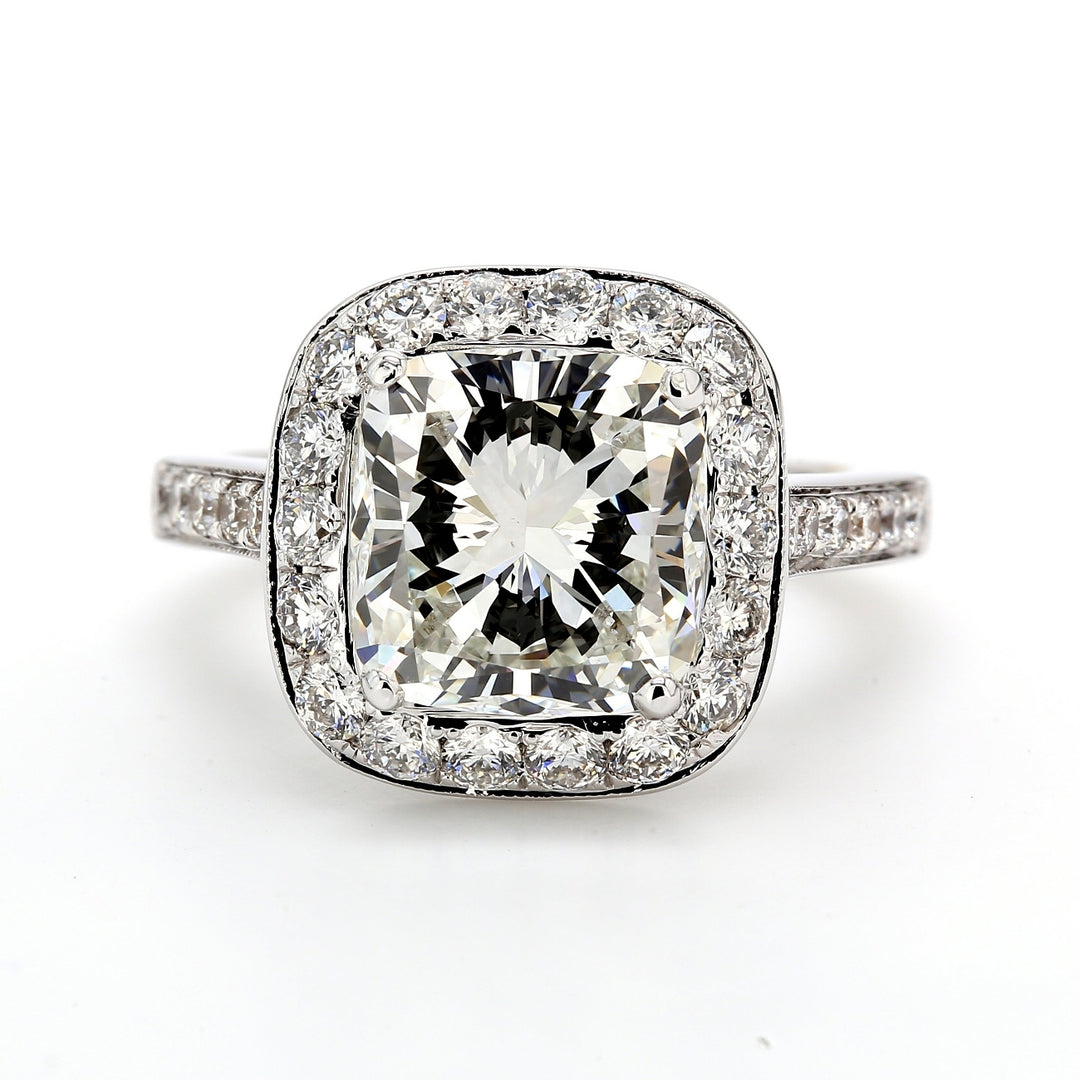 Halo semi mount in 18K WG with pave and bezel set round diamonds.  D1.14ct.t.w.  Size 6.25