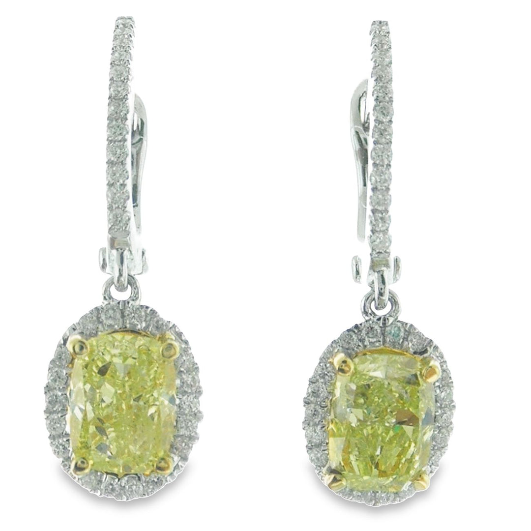 Halo dangling earrings in 18K WG with French pave set rounds around prong set fancy yellow oval diamonds.  D1.99ct.t.w.