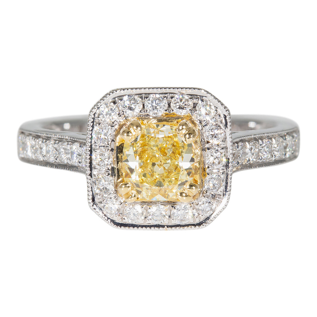 Halo ring in 18K WG with milgrain accents, pave and bezel set rounds, and a double 4-prong set FY cushion cut diamond center stone.  D1.32ct.t.w.  (Center 0.71ct.)