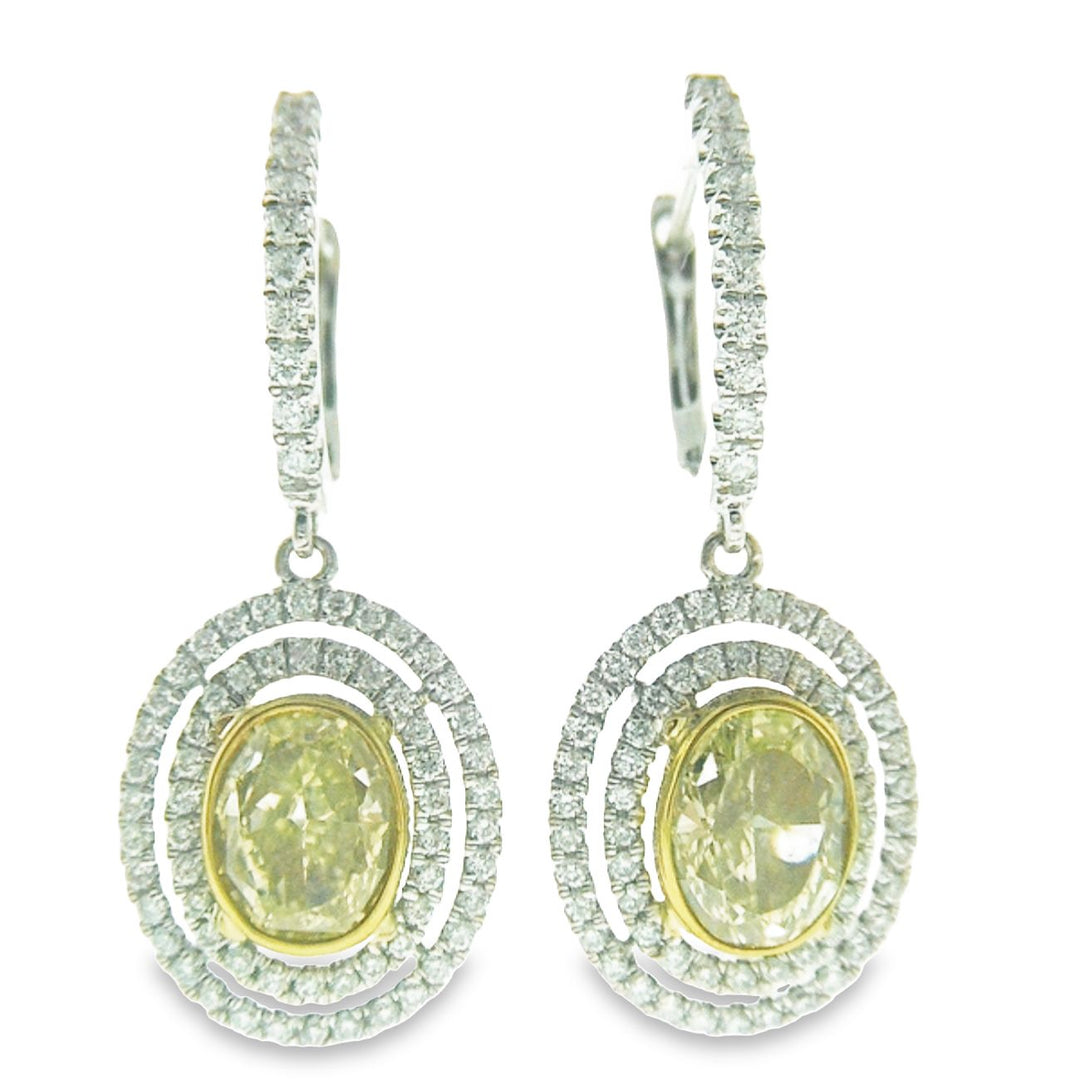 Double halo dangling earrings in 18K WG French pave set rounds around bezel set fancy yellow oval diamonds.  D2.41ct.t.w.