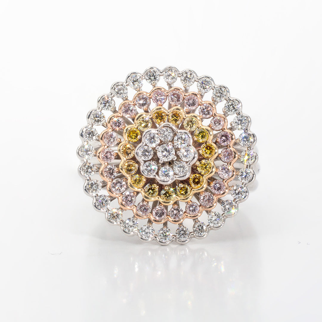 Fashion ring in with five circular rows of pink, yellow, and white prong and half-bezel set round diamonds with slightly swivelling center.  D1.42ct.t.w.
