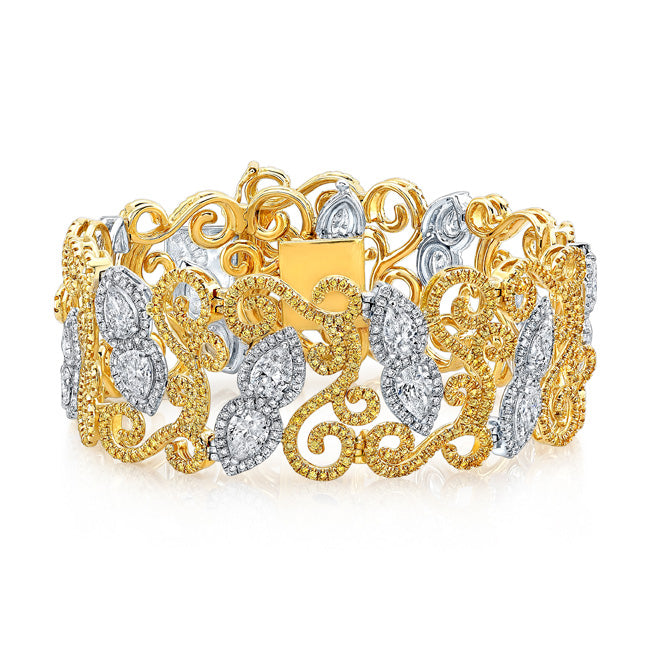 Designer wide halo bracelet in 18K two-tone with french pave set white and yellow rounds around prong set pear shape diamond center stones.  D12.15ct.t.w.