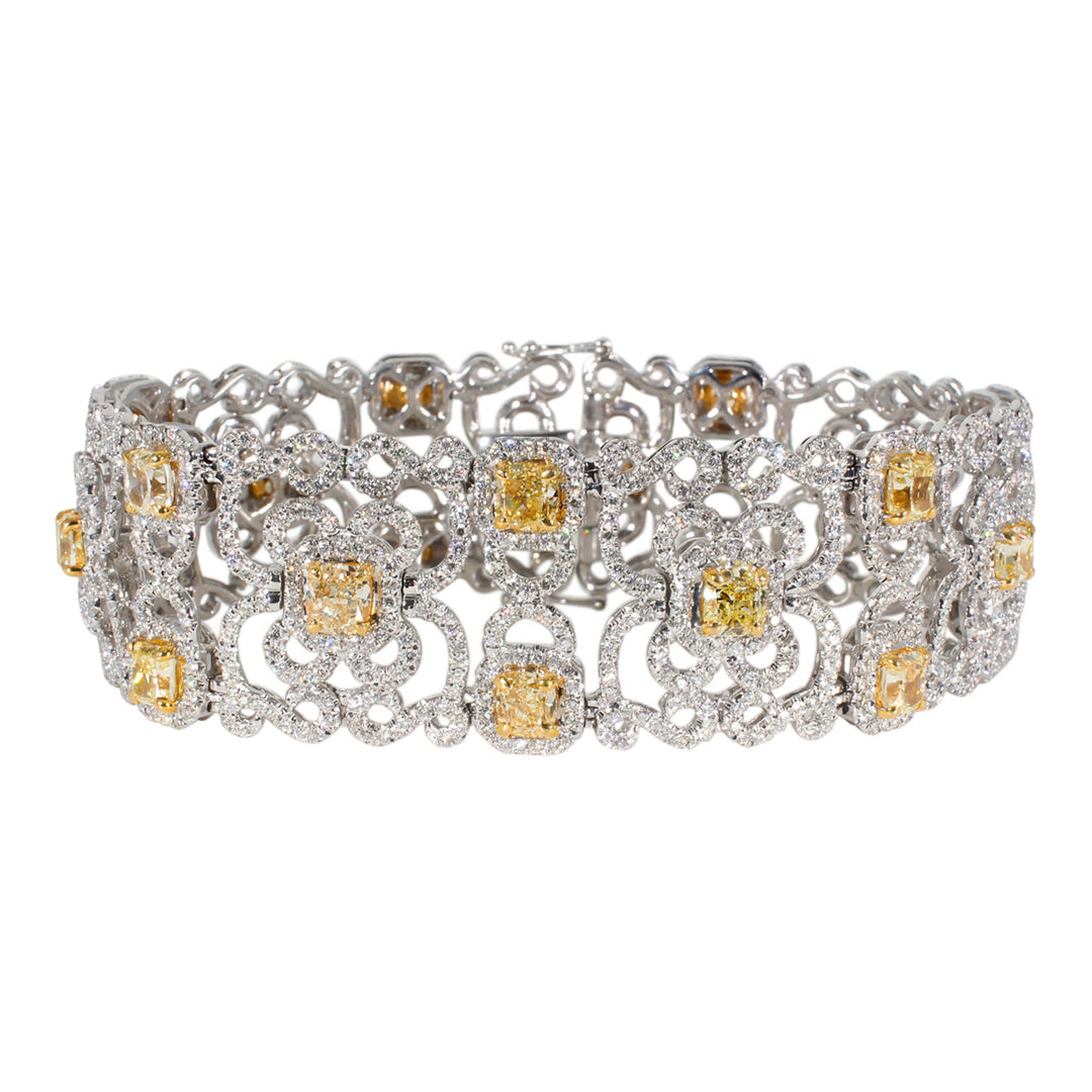 Designer style bracelet in 18K WG with French pave set rounds around prong set FY cushion cut diamond center stones.  D17.73ct.t.w.