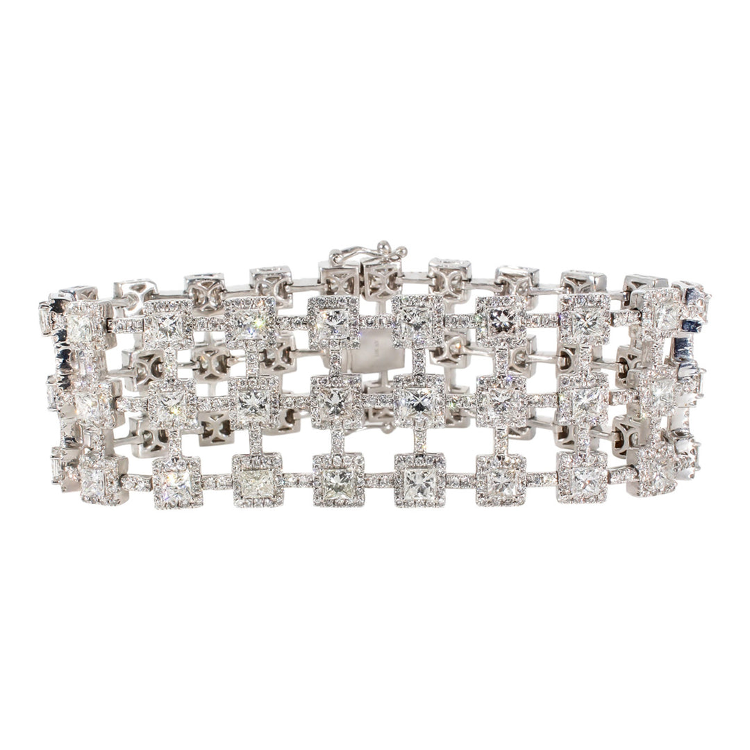 Designer bracelet in 18K WG with pave set rounds around prong set princess cut diamonds.  D16.46ct.t.w.
