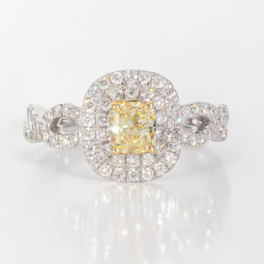 Double halo criss cross shank ring in 18K WG with rounds around a FY cushion cut diamond center stone.  D1.16ct.t.w.  (Center 0.58ct.)  Size 6.75