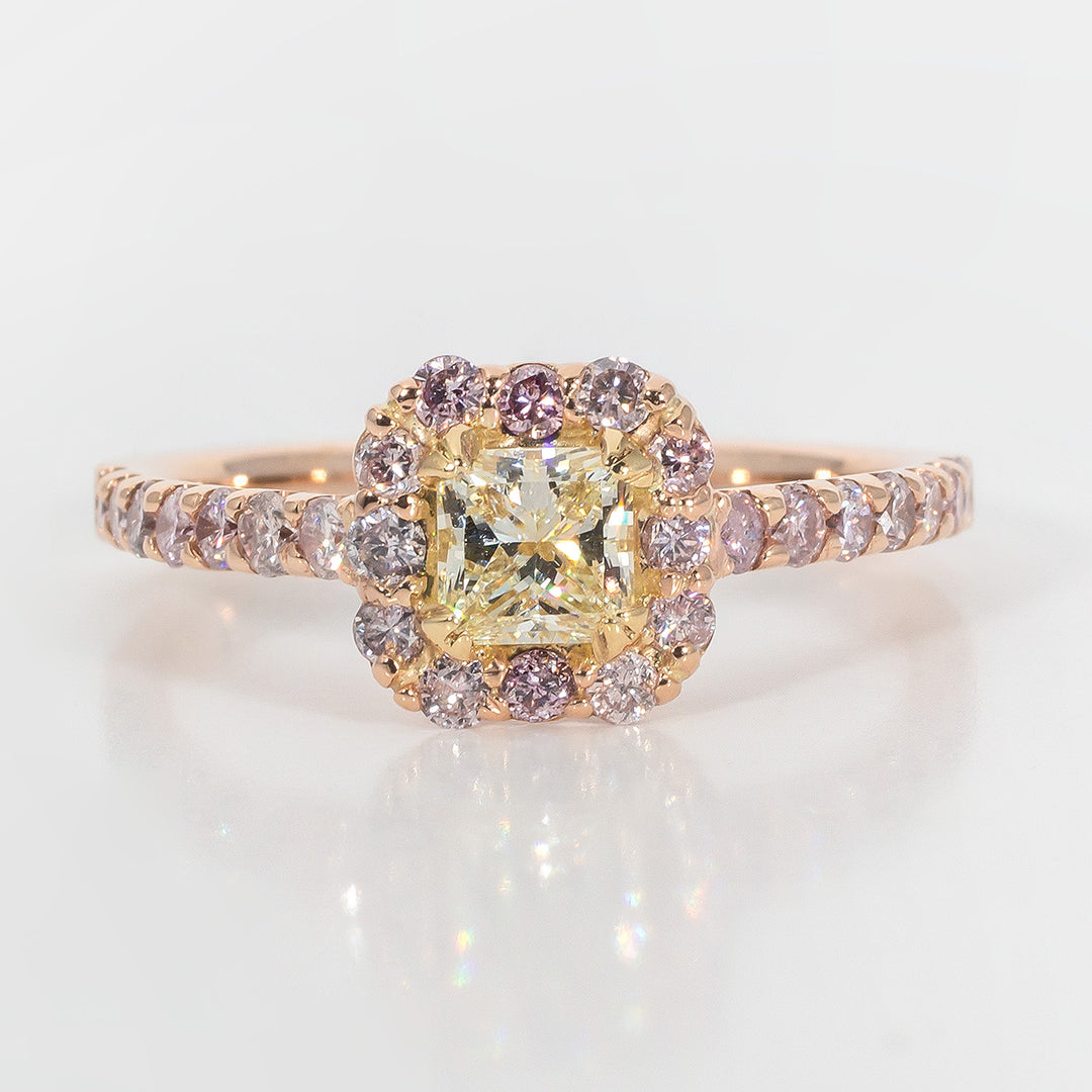 Halo ring in rose gold with U-prong set pink rounds & 4-prong set fancy yellow princess cut diamond center.  D0.95ct.t.w.  (Center 0.42ct.)