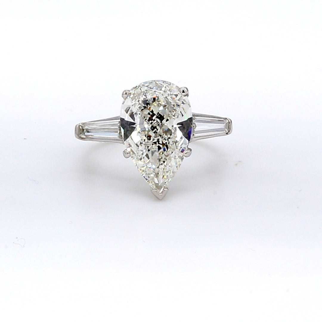3-stone Ring in platinum with GIA certified H/VS2 pear shape center and channel set baguette diamond sides.  D5.01ct.t.w.  (Center 4.01ct.)  Size 4.75