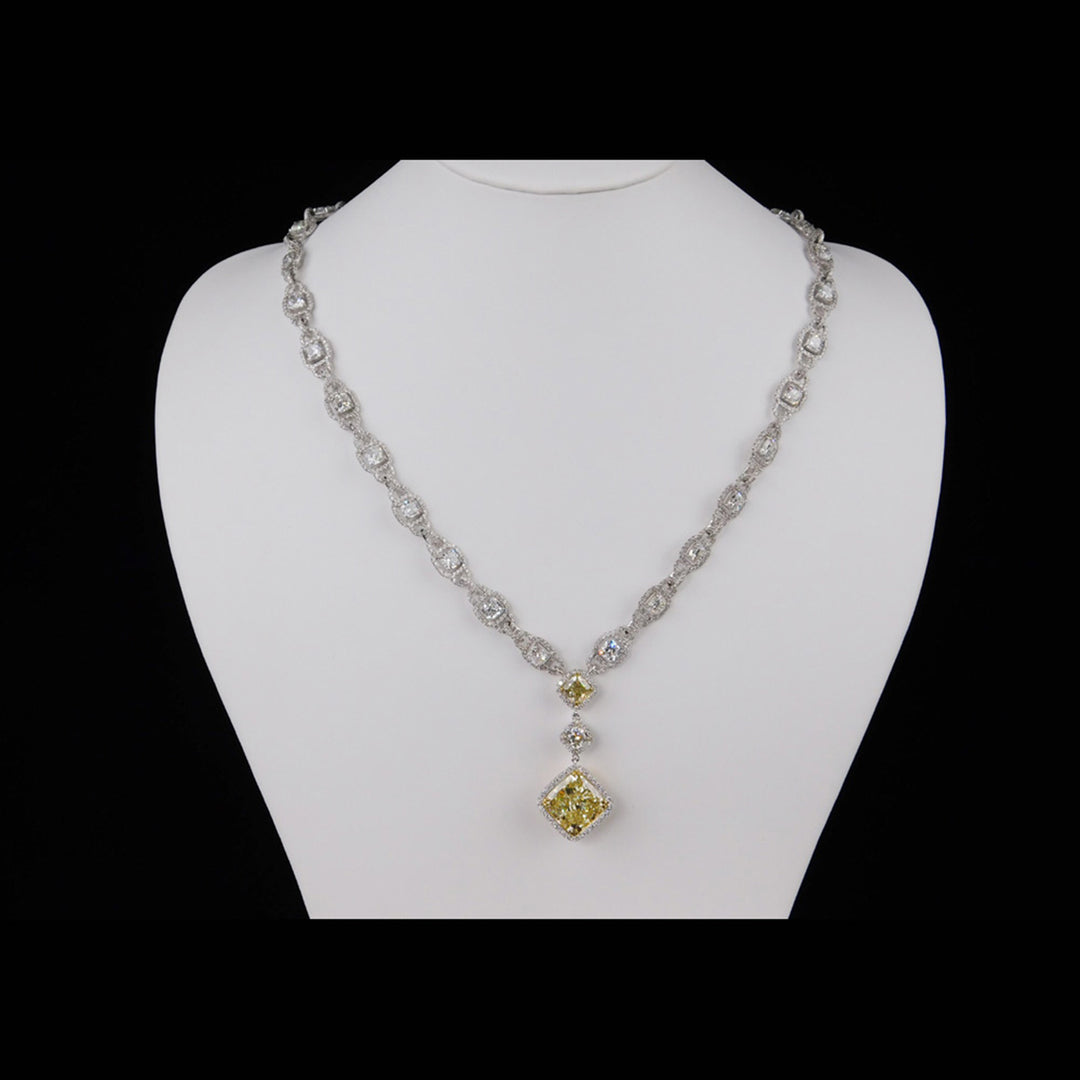 Halo necklace in 18K WG with links of French pave set rounds around prong set cushion cut diamond centers and a 3-stone halo pendant with GIA certified FLY/SI2 cushion cut diamond center.  D30.80ct.t.w.  (Center - 9.06ct.)