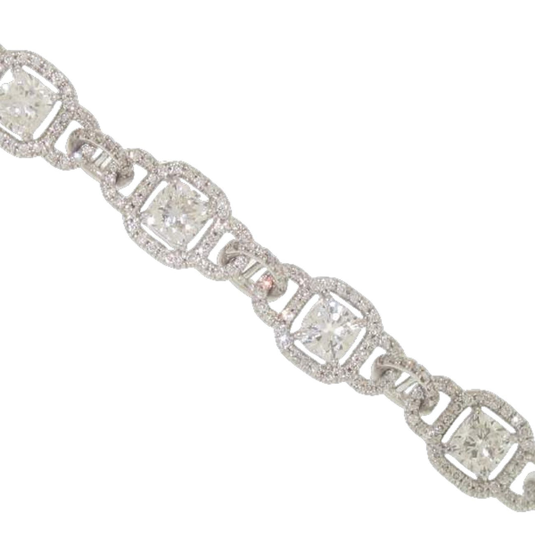 Halo bracelet in 18K WG with pave set rounds around prong set cushion cut diamond center stones.  D8.68ct.t.w.