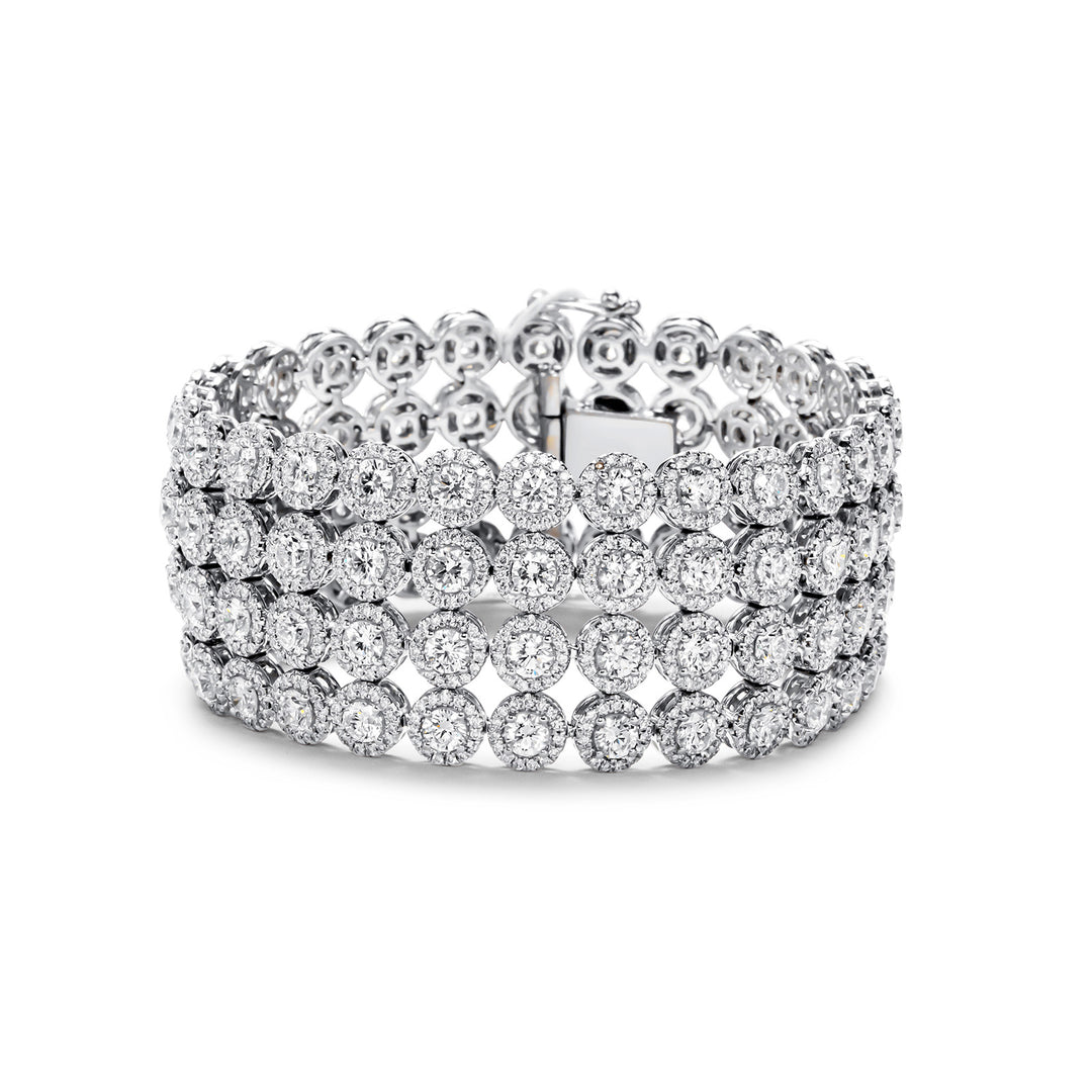 Halo 4-row bracelet in 18K WG with French pave set rounds around prong set round diamond center stones.  D26.92ct.t.w.