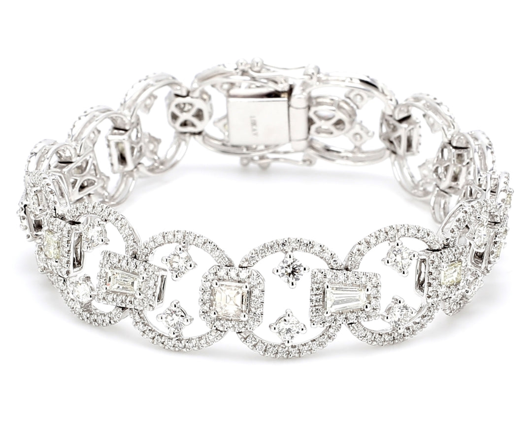 Designer halo bracelet in 18K WG with french pave set round diamond sides & prong set rounds and fancy shape diamond centers.  D7.48ct.t.w.
