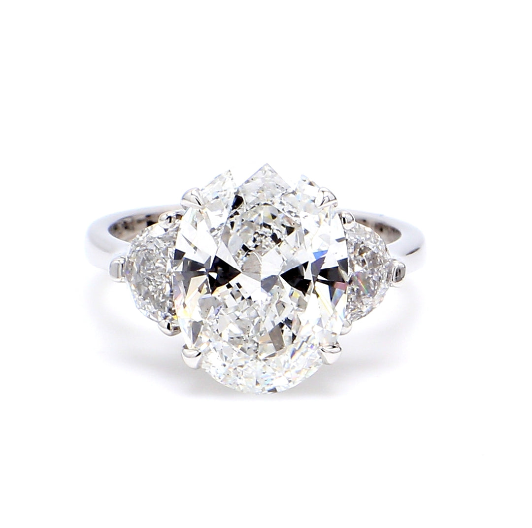 3-stone ring in 18K WG with GIA certified E/VS2 oval center and 3-prong set half moon diamond sides.  D5.76ct.t.w.  (Center 4.85ct.)