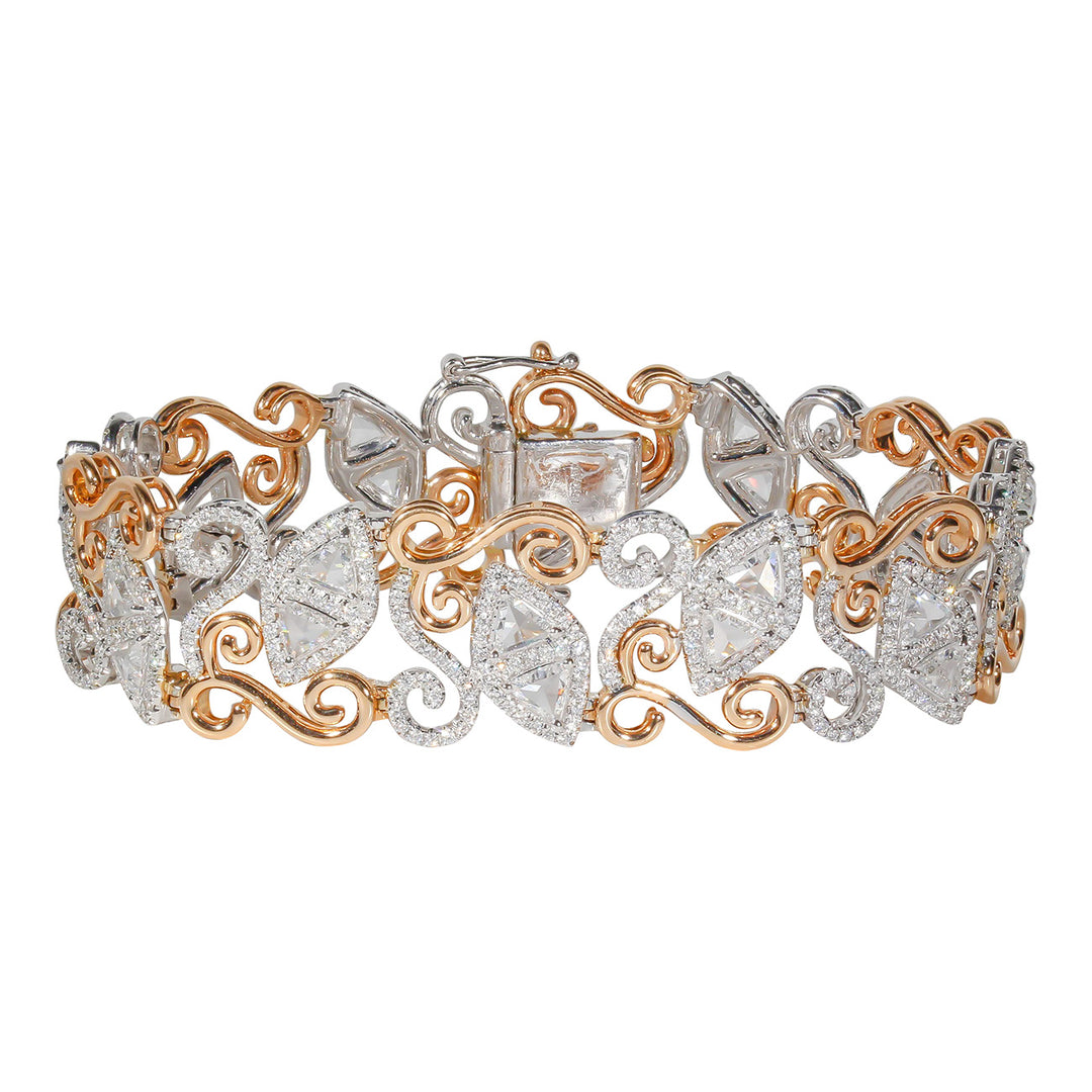 Designer halo bracelet in 18k 2-tone with swirly rose gold lining, french pave set rounds, & prong set trilliant cut diamonds.  D7.94ct.t.w.