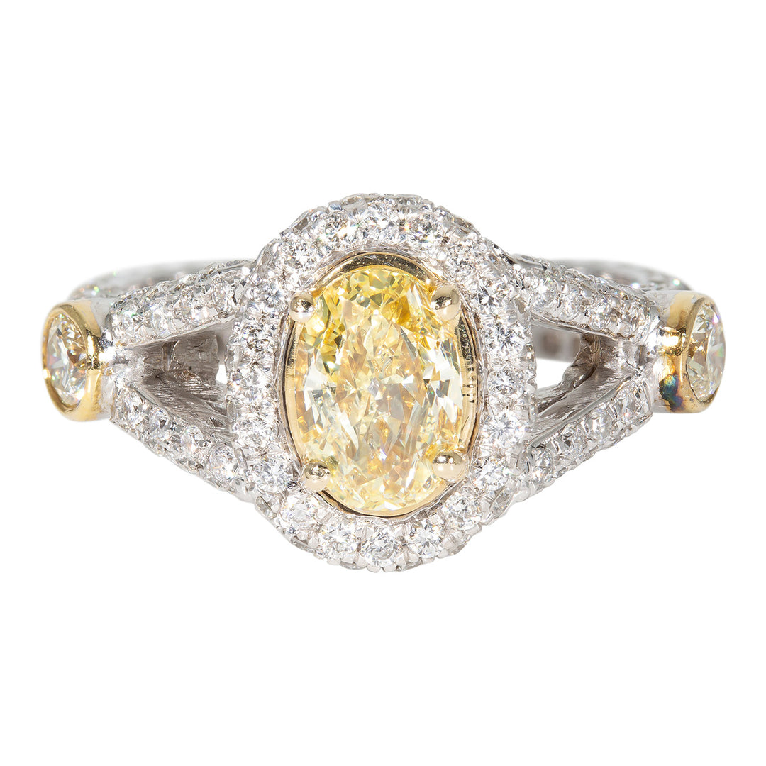 Halo split shank ring with pave and bezel set rounds around 4-prong set FY oval diamond center stone.  D1.69ct.t.w.  (Center 0.90ct.)