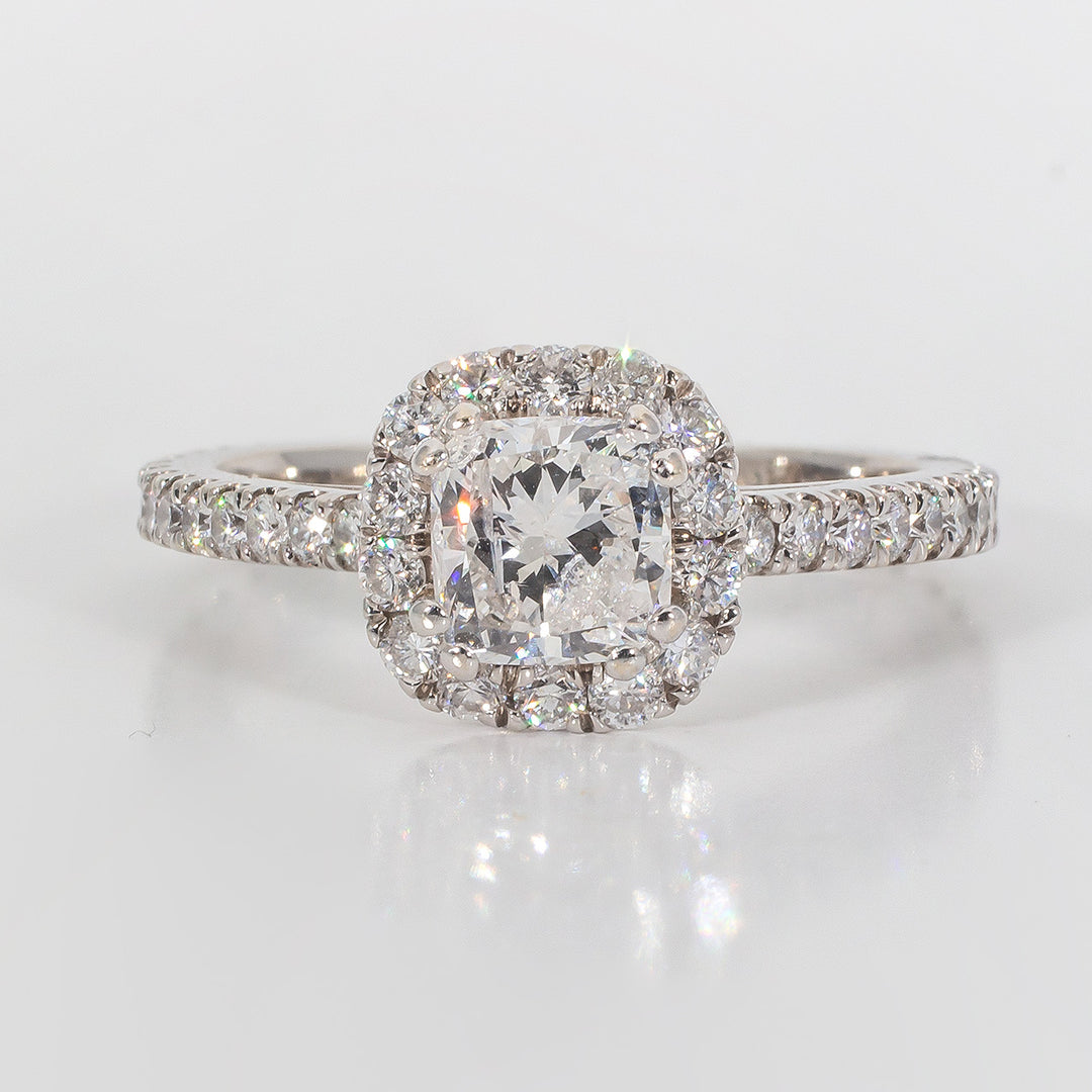 Halo ring with U-prong set rounds & double 4-prong set cushion cut diamond center.  D1.50ct.t.w.  (Center 0.83ct.)