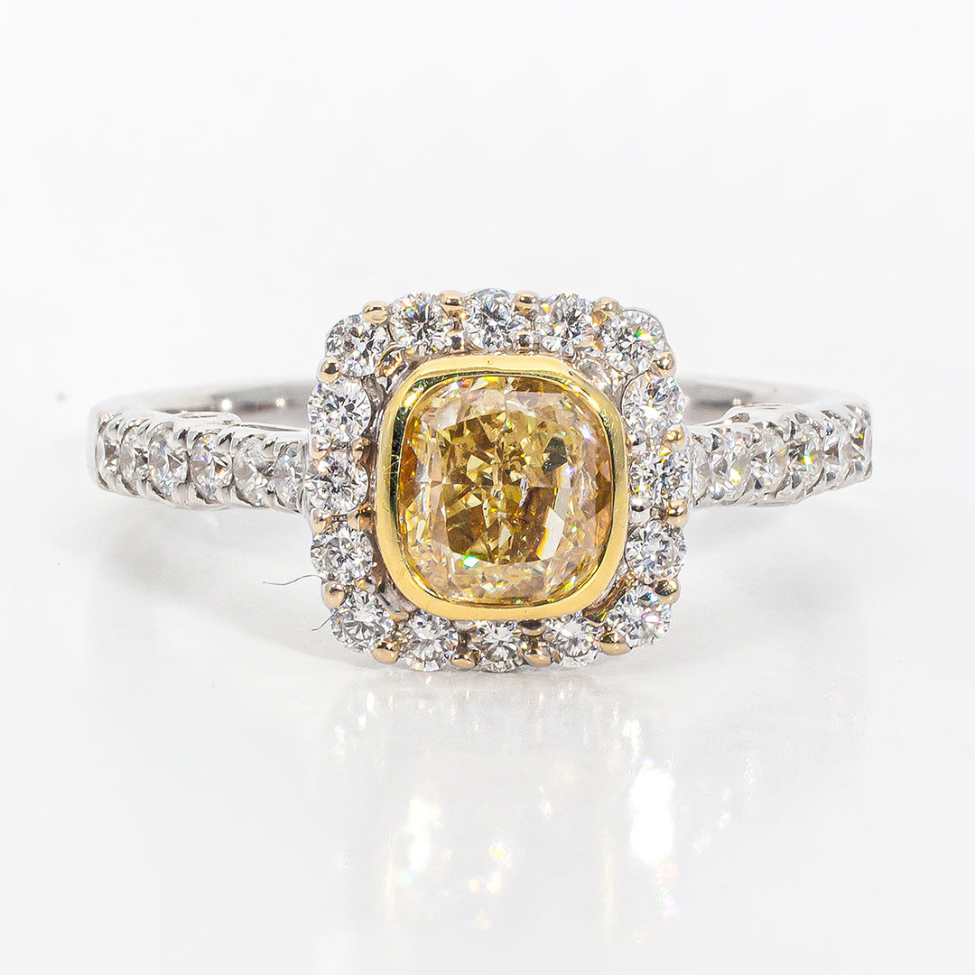 Halo ring in 18K WG with rounds around a bezel set FY cushion cut diamond center stone.  D1.50ct.t.w.  (Center 1.00ct.)  Size 6.75