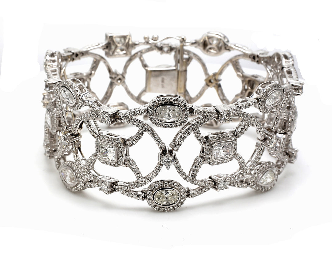 Halo designer bracelet in 18K WG with prong set rounds around fancy shaped diamond center stones.  D15.53ct.t.w.