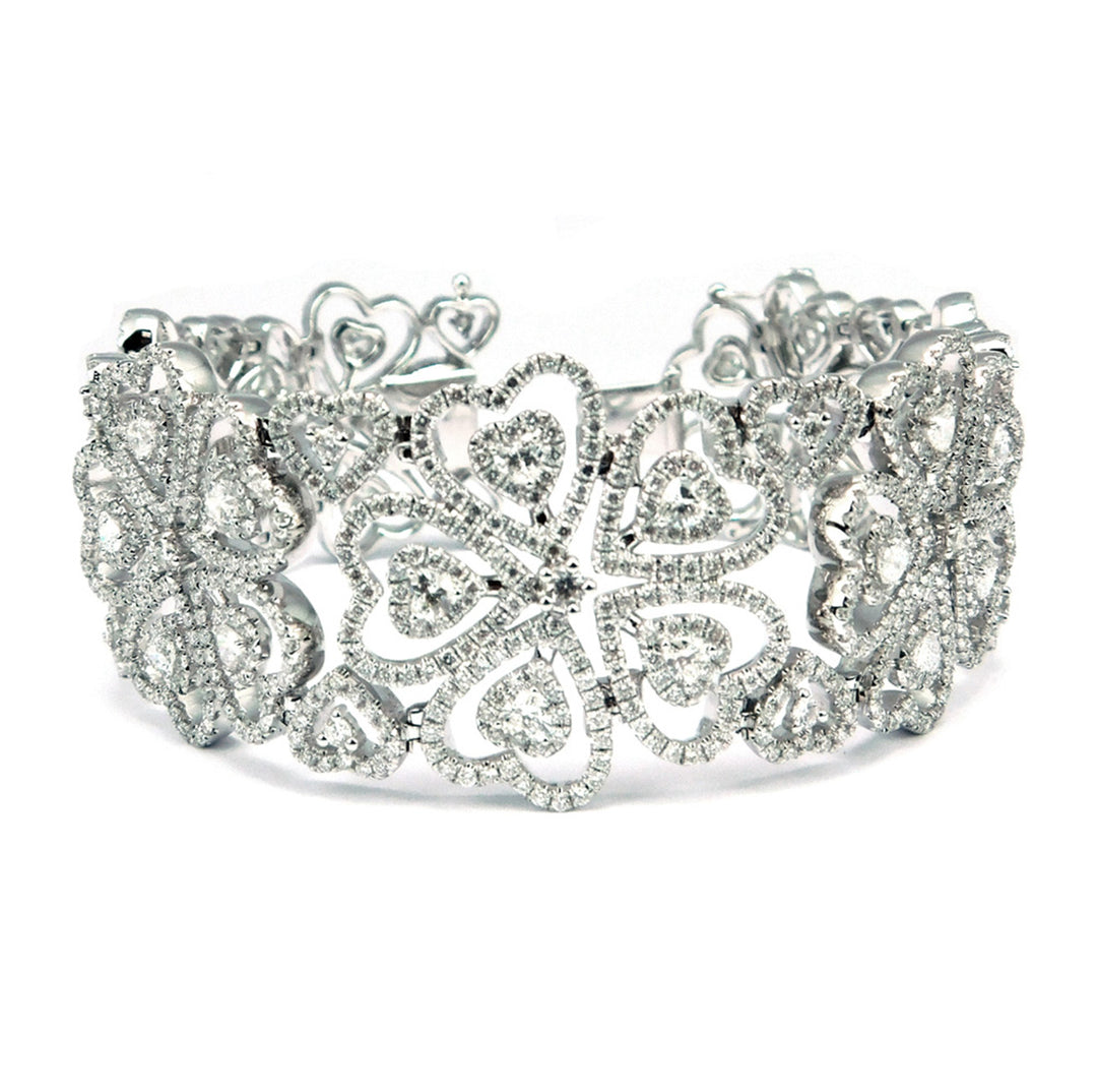 Designer bracelet with heart design in18K WG with prong and pave set round diamonds.  D13.73ct.t.w.