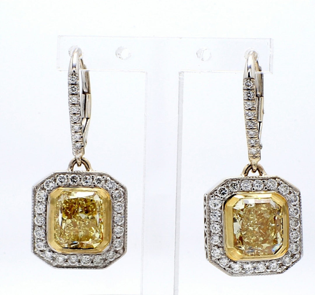 Halo dangling earrings in 18K WG with bezel set GIA certified FY/VS2 cushion cut centers & pave set round diamonds.  D5.92ct.t.w.  (Center 5.10ct.)