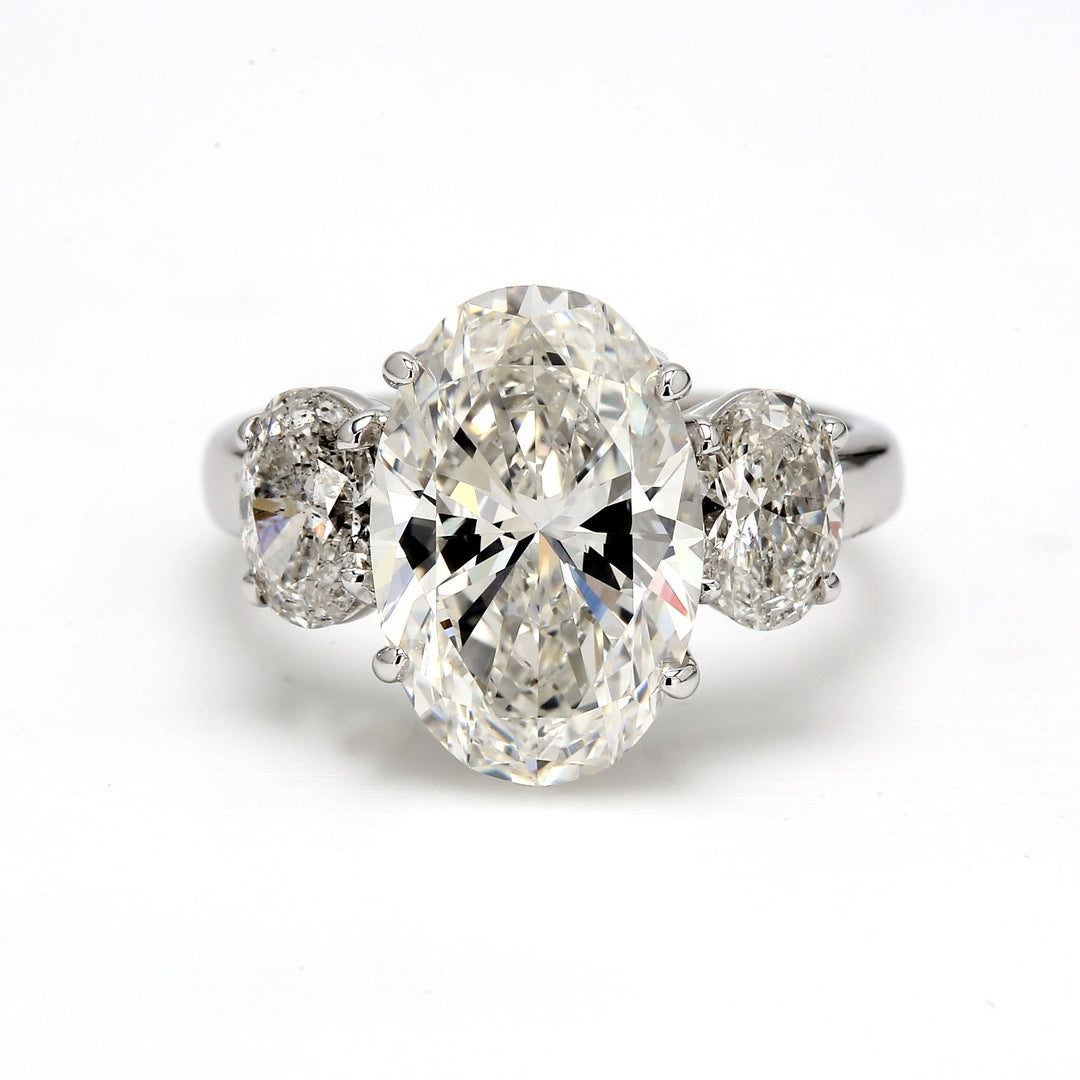 3-stone semi-mount with claw prong set oval cut diamond sides.  D1.29ct.t.w.