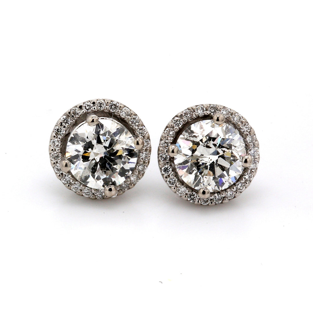 Halo stud earrings with prong set rounds around USA certified F-G/SI3 round diamonds.  D1.86ct.t.w.