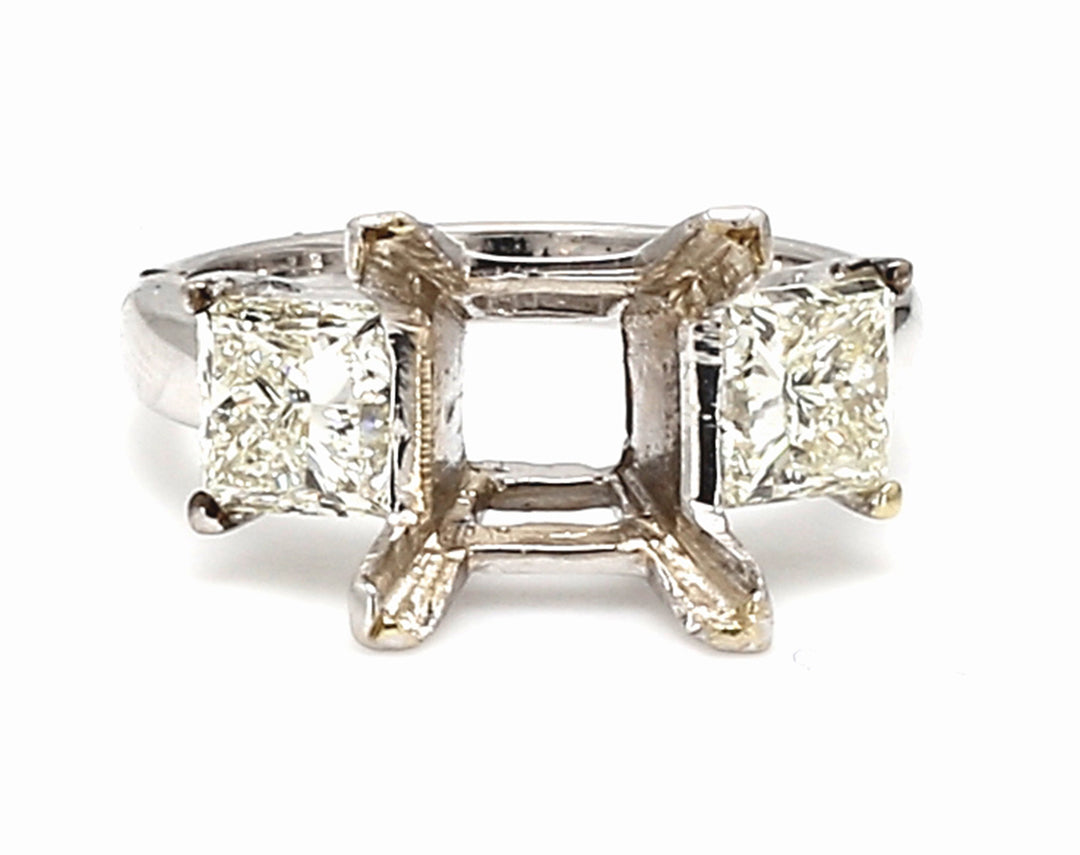 3-stone semi-mount in 18K WG w/ prong set princess cut diamond side stones.  D2.01ct.t.w.