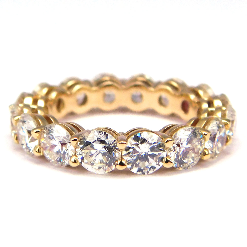 Eternity band in yellow gold with shared prong set (16) round diamonds.  D4.11ct.t.w.