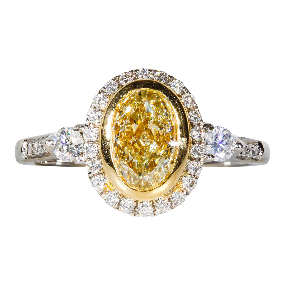 Halo ring in 18K WG with prong and pre-set rounds around GIA certified FLY/SI1 oval diamond center stone.  D1.36ct.t.w.  (Center 1.02ct.)