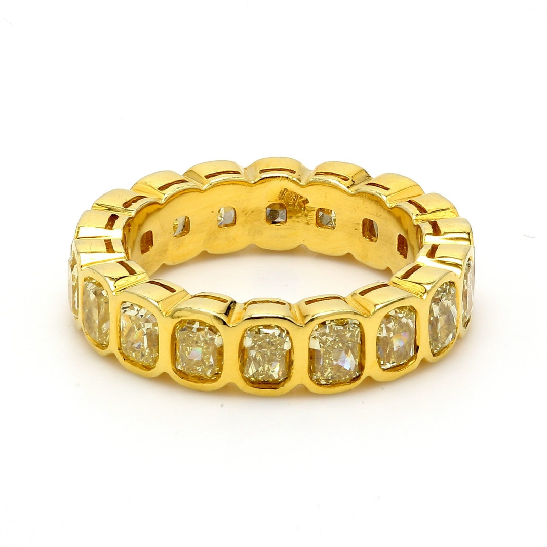 Eternity band in 18K YG with bezel set fancy yellow cushion cut diamonds.  D3.50ct.t.w.  Size 4.5