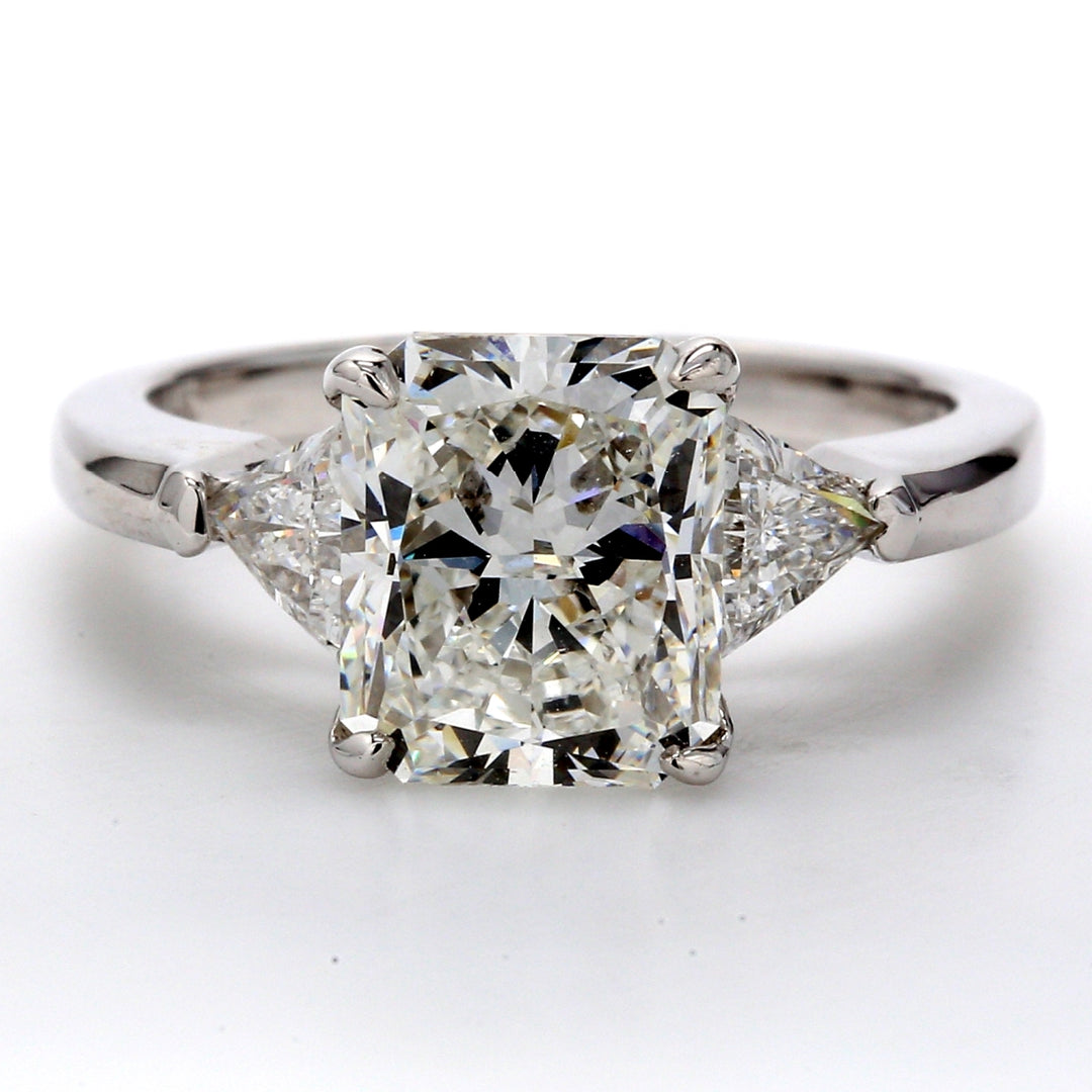 3-stone ring  with 4-prong set GIA certified H-VS1 radiant cut center and trilliant cut diamond sides.  D3.61ct.t.w.  (Center 3.01ct.)