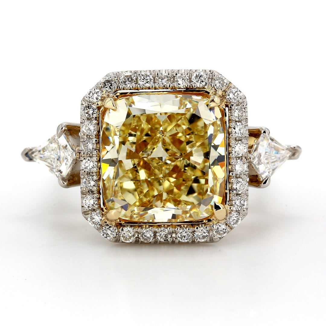 Halo ring in platinum and 18K YG with prong set kite shape sides, pre-set rounds, & GIA certified FY/SI1 cushion cut diamond center.  D8.97ct.t.w.   (Center 8.00ct.)