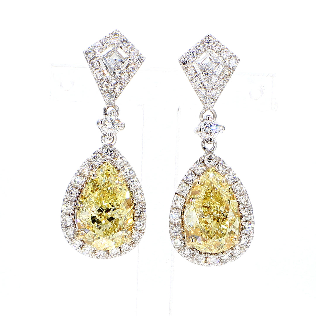Halo dangling earrings with GIA certified FY/SI1 pear shape centers, kite shapes, & round diamonds.  D7.56ct.t.w.  (Centers 6.27ct.t.w.)
