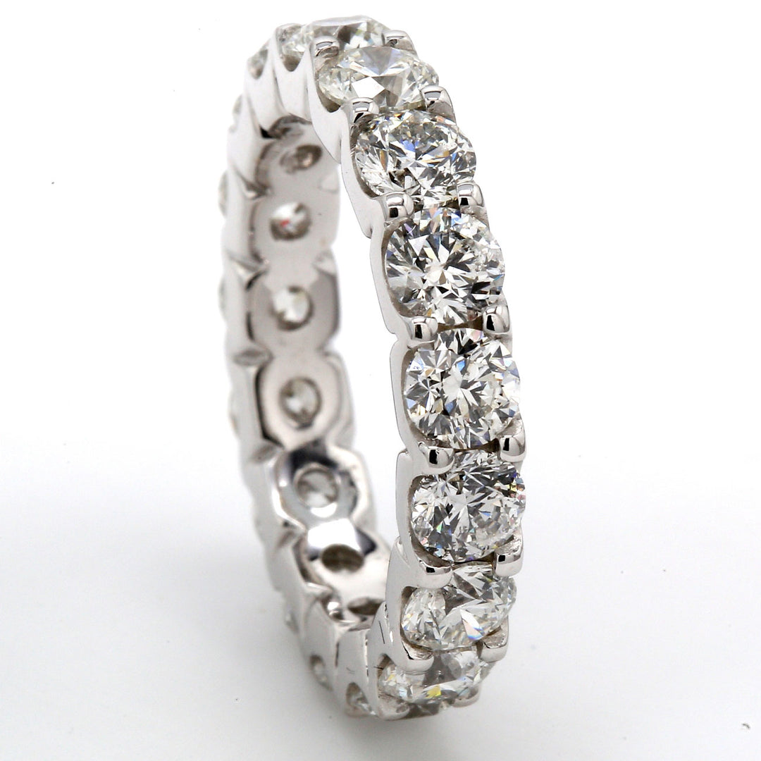 Eternity band with shared U-prong set (17) round diamonds.  D5.25ct.t.w.  Size 8