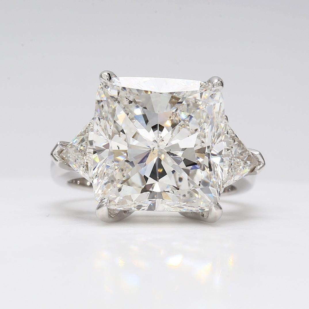 3-stone ring with 4-prong set USA certified J/VS2 cushion cut center and 3-prong set trilliant diamond sides.  D13.43ct.t.w.  (Center 11.88ct.)