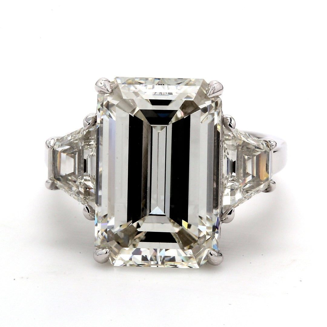 3-stone ring in platinum with GIA certified K/VS2 emerald cut center and step cut trapezoid diamond sides.  D11.45ct.t.w.  (Center 10.03ct.)